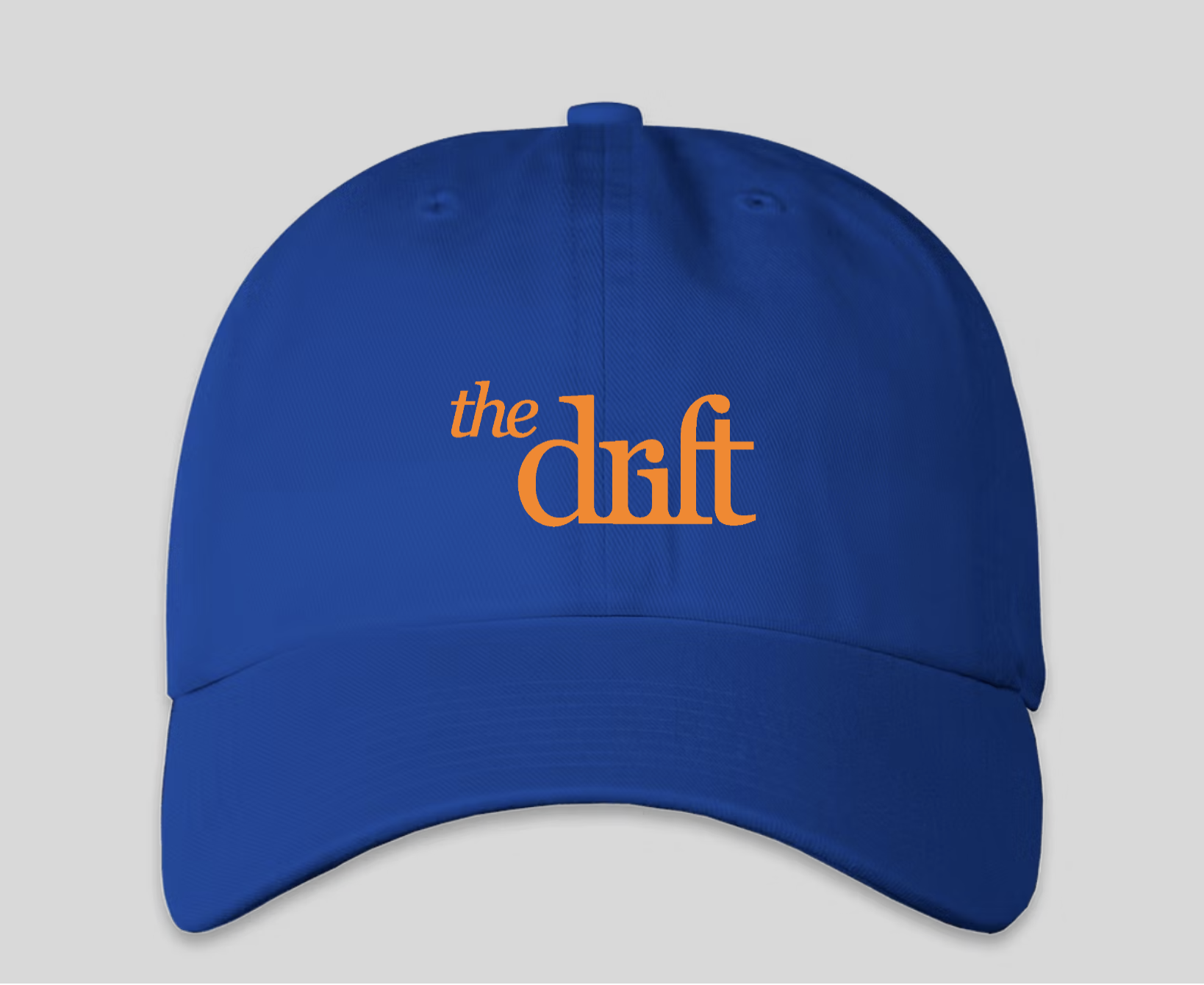 A blue cap with The Drift logo on the front in orange text.